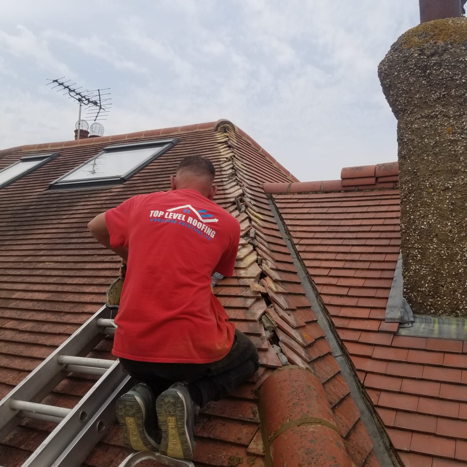Roof repair beside a chimney by Top Level Roofing & Building Solutions