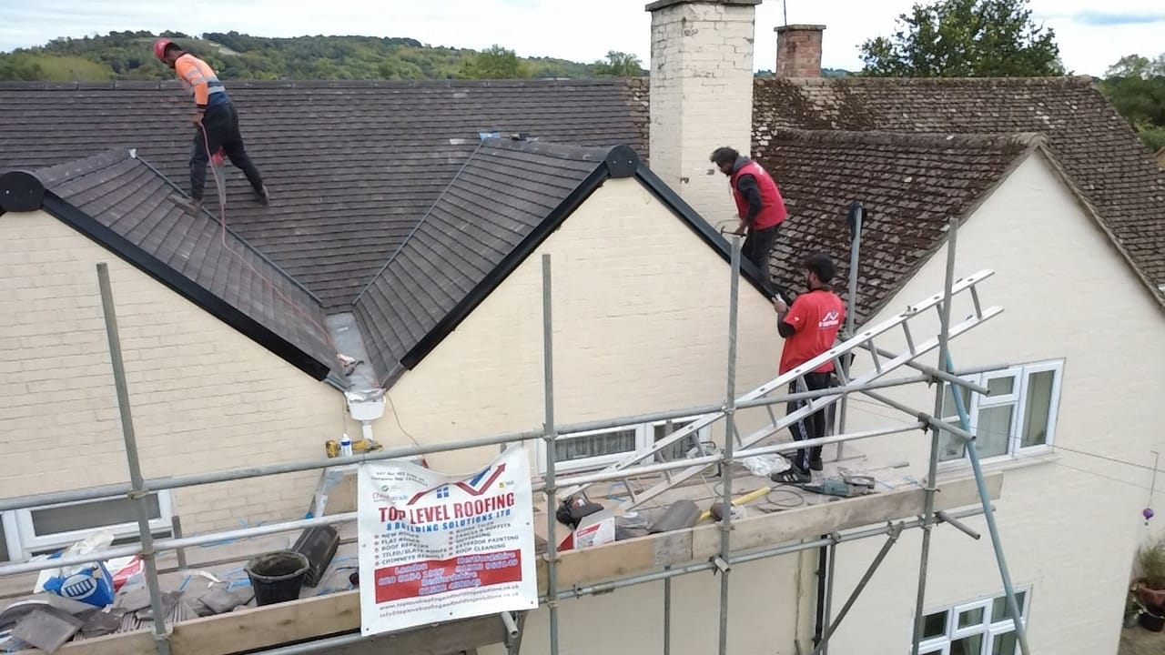 The Top Level Roofing team on scaffold during a re-roof