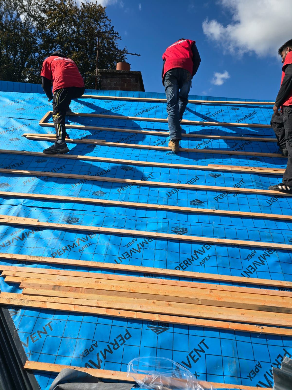 The Top Level Roofing crew installing a new roof over membrane and battens